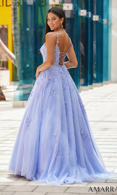 A woman wearing the Amarra 88590 Floral Lace Prom Ball Gown, a light purple floor-length dress with a lace-up back, stands outdoors and looks over her shoulder.