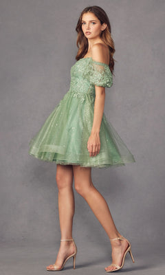 A woman stands against a gray background in the Puff-Sleeve Short A-Line Shimmer Prom Dress 886—a light green, off-the-shoulder, lace dress with sheer sleeves and sparkly accents—paired with nude high-heeled sandals.