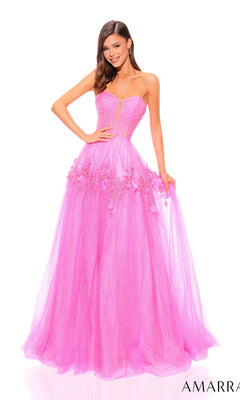 A woman showcases the Amarra Strapless Long Glitter Prom Ball Gown 88874, a floor-length bright pink dress with a corset-style bodice and floral appliqués, posing against a plain white background.