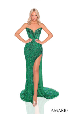 A woman stands confidently with hands on hips in the Amarra 88915, a strapless, fitted green prom dress featuring sparkly beaded detailing, a thigh-high slit, and a floor-length silhouette against a white background.