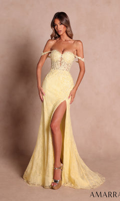 A woman stands against a beige background wearing the Amarra 88930 Off-Shoulder Long Lace Prom Dress in light yellow, featuring intricate lace detailing, a sheer corset bodice, and a thigh-high slit.