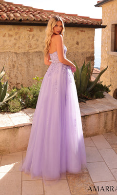 A woman with long blonde hair stands outdoors in front of a stone wall, wearing the Strapless Embroidered Prom Ball Gown: Amarra 88950—a lavender floor-length tulle gown with floral embroidery and a sweetheart neckline.