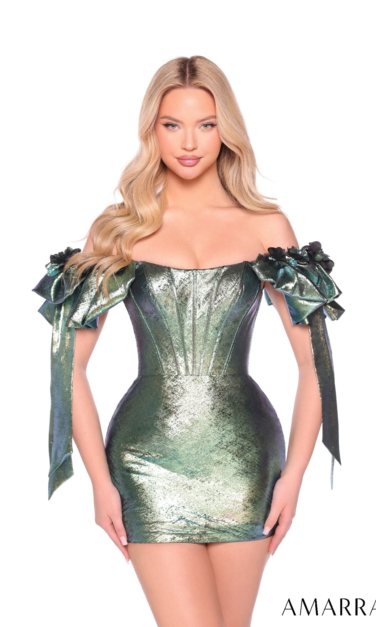 A woman stands against a white background wearing the Bow Short Metallic Hoco Dress: Amarra 88953, a shiny green off-the-shoulder homecoming dress featuring floral and ribbon sleeve details.