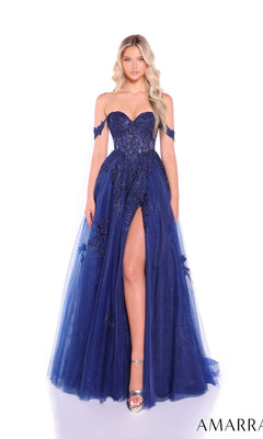A woman in the Amarra 88963 Off-Shoulder Corset Prom Ball Gown, featuring a deep blue hue, high slit, floral appliqué, sheer corset bodice, and tulle overlay stands against a white background.