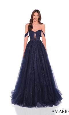 A woman wears the Amarra 88970, a navy blue off-the-shoulder long prom dress with a glitter tulle skirt and sequin embellishments, standing against a white background.
