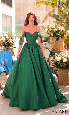 A woman in the Amarra 88995 Lace-Up Off-Shoulder Prom Ball Gown stands outdoors near a blue scooter and vibrant flower arrangements.