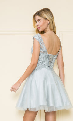 A woman in a Lace-Bodice Short Babydoll Homecoming Dress 8902 stands with her back turned, highlighting the lace-up detail and flattering a-line silhouette of this charming party dress.