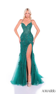 A woman poses against a white background wearing the Amarra 89022, an embroidered-lace long prom dress featuring emerald green fabric, a fitted silhouette, open back, floral details, thin straps, and a high thigh slit.