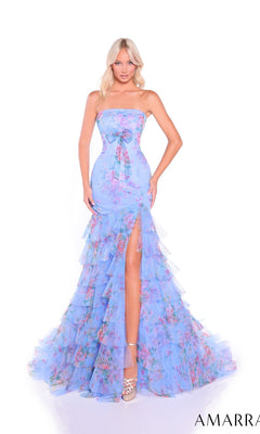 A woman models the Amarra 89075 long prom dress, which features a strapless fitted bodice and a light blue floral chiffon tiered skirt with ruffled layers and a high slit, against a white background.