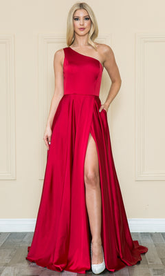 A woman stands indoors against a neutral wall, wearing the One-Shoulder Long Prom Dress with Pockets 8912—a floor-length red A-line gown with a high slit—and pairs it with silver high-heeled shoes.