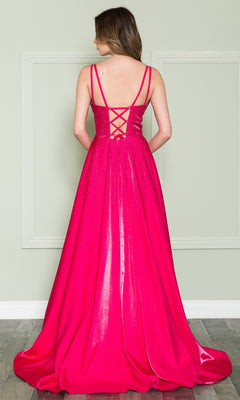 A woman stands facing away, wearing the Poly USA 8922 long beaded a-line prom dress in hot pink with thin straps and a lace-up back, posed against a light-colored wall with molding.