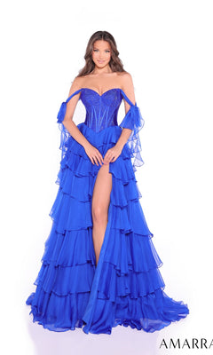 A woman models the Long Prom Dress: Amarra 89285, showcasing a royal blue off-the-shoulder gown with an embellished corset bodice and a ruffled high-slit tiered chiffon skirt against a white background.