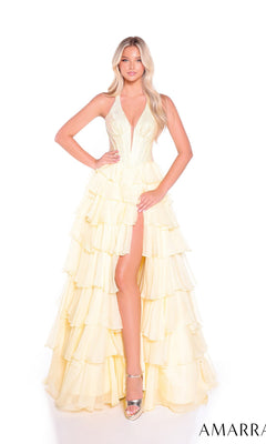 A woman wears the Amarra 89287 long prom dress in pale yellow, featuring a halter neckline, embellished corset bodice, and high slit. She pairs it with silver heels while standing against a white background. The AMARRA logo is at the bottom right.