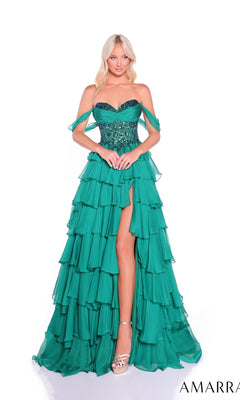 A woman wears the Amarra 89313 long prom dress—an off-shoulder emerald green gown with a chiffon tiered skirt, beaded bodice, thigh-high slit—and silver high heels, posing against a white background.