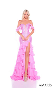 A woman stands facing forward against a white background, wearing the Amarra 89345 long prom dress—a sparkly pink off-the-shoulder gown with a corset bodice and ruffled organza layers.