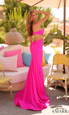A woman wears the Amarra 89369 Sexy Cut-Out Long Prom Dress in bright pink, featuring a strappy open back, as she poses outdoors near a white sofa with colorful pillows and yellow chairs.
