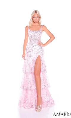 A woman stands against a white background wearing the Amarra 89377, a light pink long prom dress featuring sequins, embellishments, a tiered tulle skirt, and a high slit.