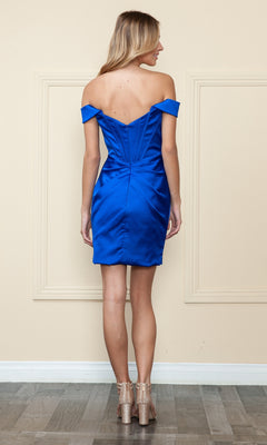A woman stands facing away, wearing the Removable Straps Short Corset Homecoming Dress 8942 in royal blue with nude heels, set against a beige wall with decorative trim.