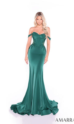 A woman stands against a white background wearing the Amarra 89431, a fitted emerald green off-the-shoulder long prom dress with a corset bodice, floral detailing, and a flared train.