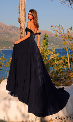 A woman wearing the Amarra 89441 long prom dress, featuring an off-the-shoulder satin bodice and A-line skirt, stands outdoors near a tree with mountains and water in the background.