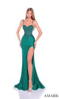 A woman wears the Amarra 89465 long prom dress—emerald green, fitted, sleeveless with a beaded bodice, high slit, and sweetheart neckline—posing against a white background and pairing it with silver high heels.