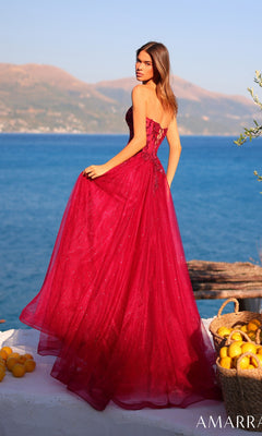 Wearing the Amarra 89486 long prom dress, a woman in a strapless glitter tulle gown with a lace-up back stands on a white seaside terrace, with mountains and baskets of lemons in the background.