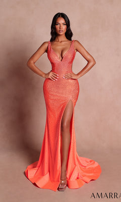 A woman models the Long Prom Dress: Amarra 89503-1 in orange, featuring a fitted silhouette, sleeveless design, deep neckline, high leg slit, and sparkling embellishments, posed against a plain beige background.