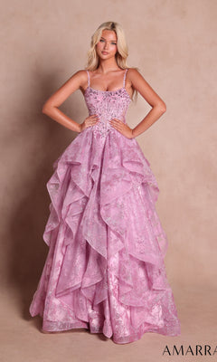 A woman stands in front of a neutral background wearing the Amarra 89505 Long Lace Handkerchief Prom Dress in rose pink, featuring shimmering beaded details, delicate thin straps, and ruffled accents reminiscent of a sparkling lace evening gown.