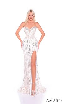 A woman poses against a white background wearing the Amarra 89605 long prom dress—a strapless, form-fitting white sequin gown with a high slit, intricate beading, and a structured bodice.