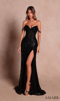 A woman wearing the Long Prom Dress: Amarra 89610 in black, featuring thin shoulder straps, a sheer corset bodice, a fitted silhouette, and an off-the-shoulder design with black sequins and a thigh-high slit, stands against a plain beige background.