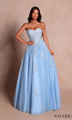 A woman stands against a plain beige background wearing the Amarra 89626 long prom dress in light blue—a strapless ball gown featuring floral lace appliqué and a fitted bodice with a sweetheart neckline.