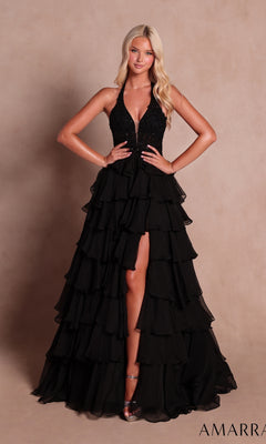 Woman wearing the Amarra 89633 long prom dress in black, featuring a sleeveless halter neckline with a deep V-neck and a tiered ruffle skirt, standing against a neutral background.