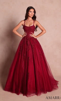 A woman wearing the Long Prom Dress: Amarra 89644 in wine—a floor-length, sleeveless gown featuring a sweetheart neckline and delicate floral lace appliqués on the fitted bodice—stands against a plain beige background.