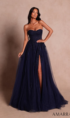 A woman poses gracefully against a plain beige background, wearing the Amarra 89689 Long Prom Dress—a navy, floor-length gown featuring a strapless sweetheart neckline and a high leg slit.