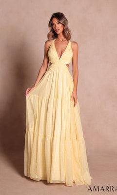 A woman wearing the Amarra 89730, a sleeveless, light yellow long prom dress with a halter neckline and tiered skirt, stands against a plain beige background.