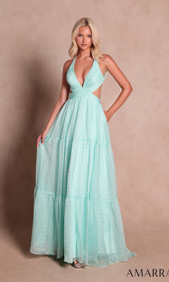 A woman poses in the mint-colored Amarra 89730 long prom dress, featuring a chic halter neckline, deep V-neckline, sleeveless design, floor-length silhouette, and stylish side cutouts as she stands against a plain beige background.