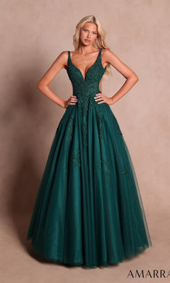 An elegant woman poses against a plain beige background wearing the Amarra 89786 long prom dress in emerald—a sleeveless gown featuring a fitted bodice embellished with floral lace appliqués and a flowing tulle skirt.
