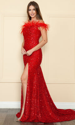 A woman models the Sequin-Velvet Long Feathered Prom Dress 8980, featuring a feathered neckline and high slit, while standing against a beige wall.