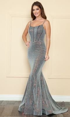 A woman stands indoors wearing the Diamond Sequin-Knit Long Mermaid Prom Dress 8992, a form-fitting silver sequin gown with thin straps and black piping accents.