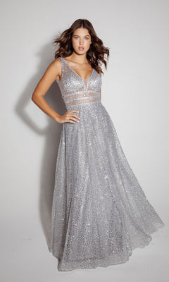 A woman poses against a plain backdrop wearing the Eureka 9005, a sleeveless long glitter formal dress with silver sequins, a deep V-neck, and sheer waist panel details.