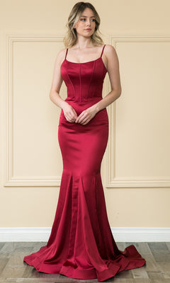 A woman stands indoors wearing the Stretch-Charmeuse Long Mermaid Prom Dress 9006, a fitted, floor-length, sleeveless red evening gown with thin straps and a mermaid silhouette.