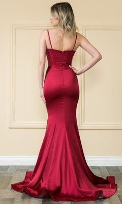 Woman wearing the Stretch-Charmeuse Long Mermaid Prom Dress 9006, a fitted, floor-length sleeveless satin gown with thin straps, standing with her back to the camera against a beige wall with decorative molding.