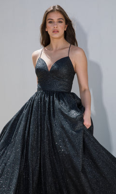 A woman models the Strappy-Back Glitter Prom Ball Gown (Eureka 9009), a sleeveless dark A-line dress with thin straps, against a plain light background.