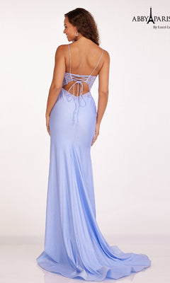 Woman wearing the Sheer Corset Glitter Prom Dress Abby Paris 90207, a floor-length light blue gown with thin straps, lace-up open back, and sparkling details.