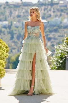 Amelia Couture 9053 strapless, mint-green tiered tulle ball gown with a beaded corset bodice and a high leg slit.