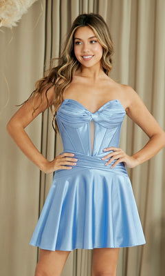 A woman poses in front of beige curtains wearing the Amelia Couture 9071S Lace-Up Strapless Hoco Dress, featuring a light blue satin finish, flared skirt, and sheer front panel—ideal for a chic semi-formal look.