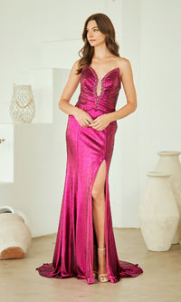 Woman wearing a vibrant pink evening gown with a high slit in a minimalistic setting.