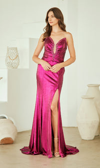 Woman wearing a vibrant pink evening gown with a high slit in a minimalistic setting.