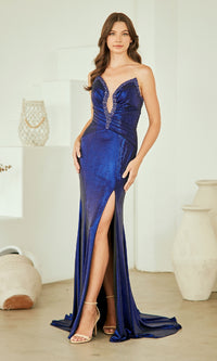 Woman wearing a navy blue evening gown with a high slit in a minimalistic setting