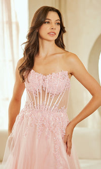 Woman wearing a pink strapless dress with lace details against a neutral background